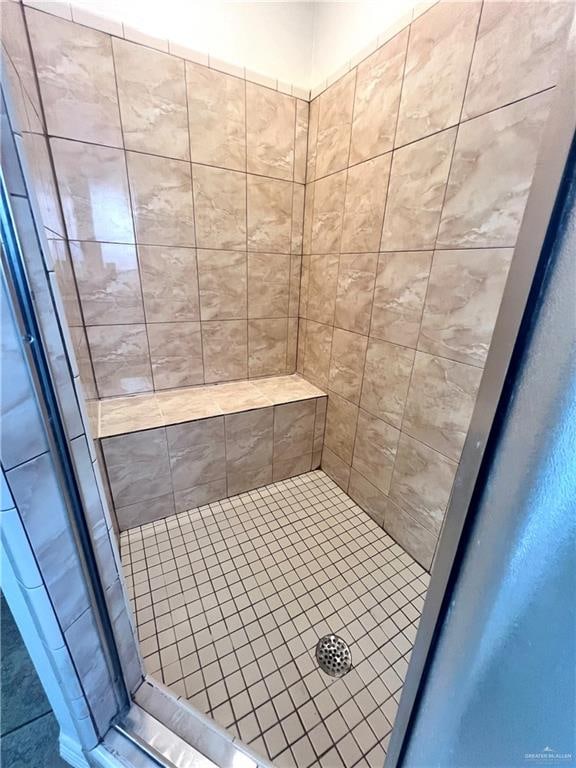 bathroom with tiled shower