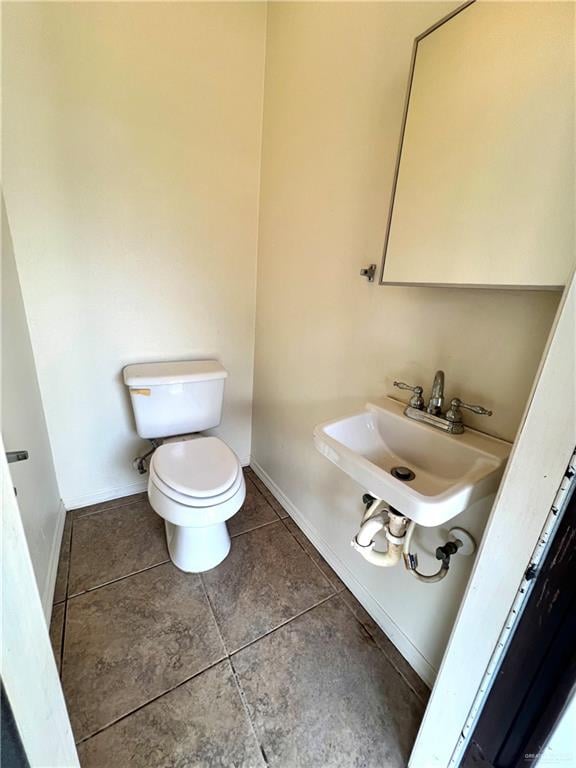 bathroom with tile patterned floors, sink, and toilet