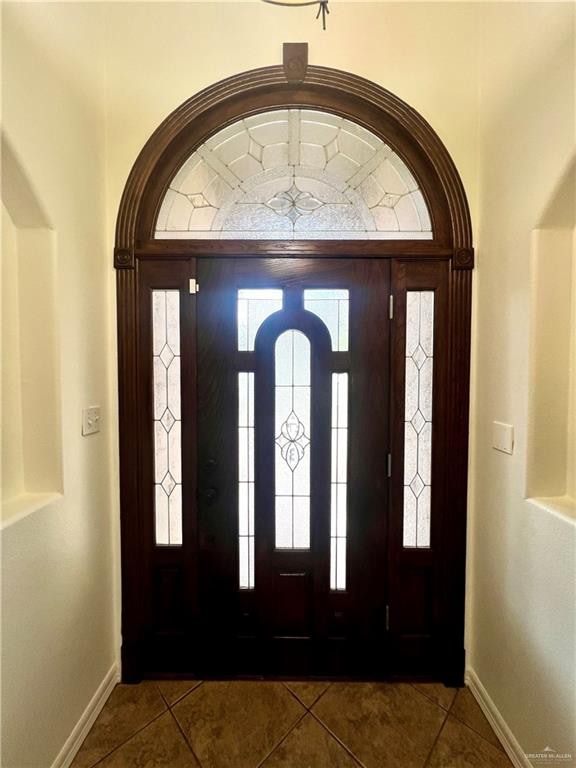 foyer with dark tile patterned flooring