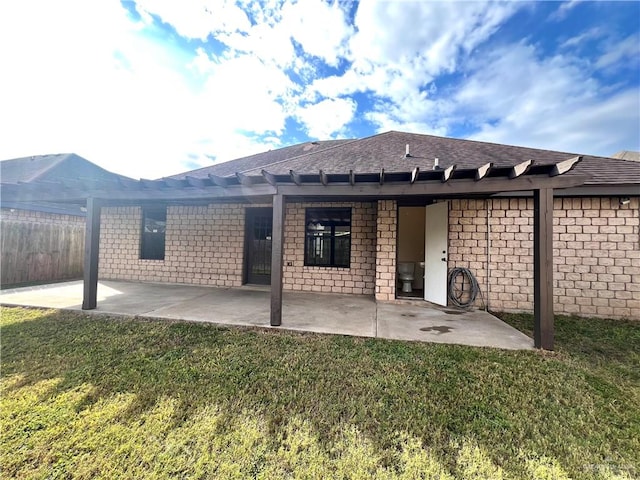 back of property featuring a lawn and a patio area