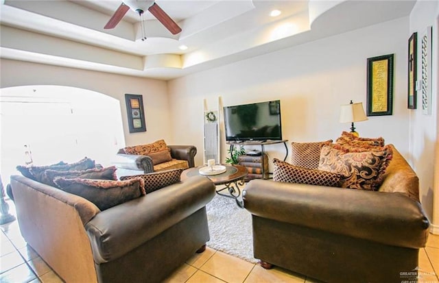2209 Benito A Ramirez Rd, Edinburg, TX 78542 - living area with light tile patterned flooring, a tray ceiling, a ceiling fan, recessed lighting, and arched walkways