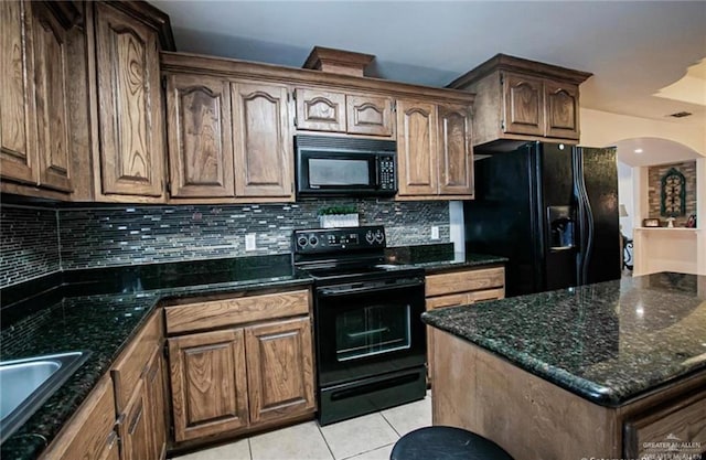 2209 Benito A Ramirez Rd, Edinburg, TX 78542 - kitchen featuring black appliances, light tile patterned flooring, decorative backsplash, and dark stone counters
