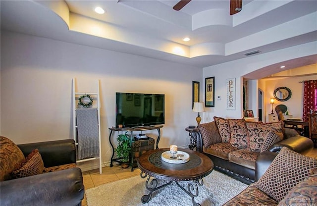 2209 Benito A Ramirez Rd, Edinburg, TX 78542 - tiled living room featuring a raised ceiling, arched walkways, a ceiling fan, and recessed lighting