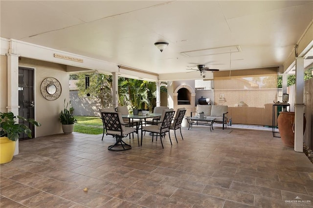 view of patio / terrace featuring ceiling fan and a fireplace