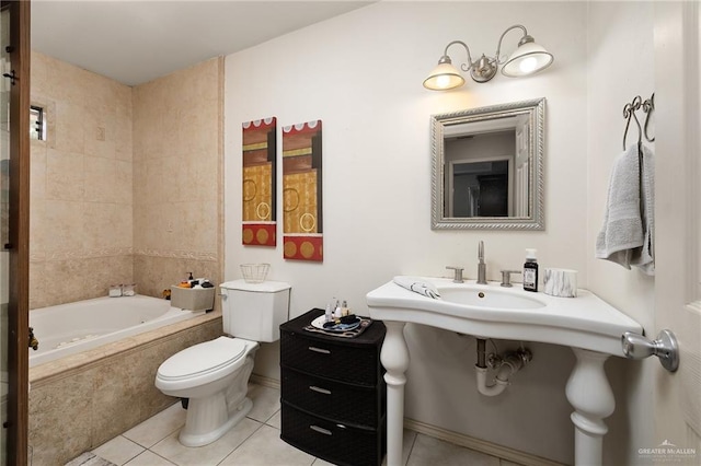 bathroom featuring toilet, tiled bath, and tile patterned floors