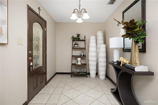 foyer featuring light tile patterned floors and an inviting chandelier