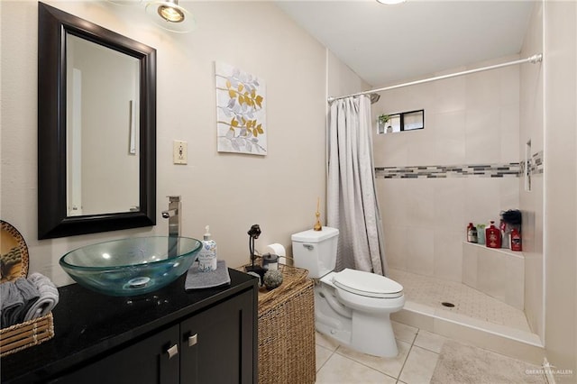 bathroom featuring tile patterned floors, curtained shower, vanity, and toilet