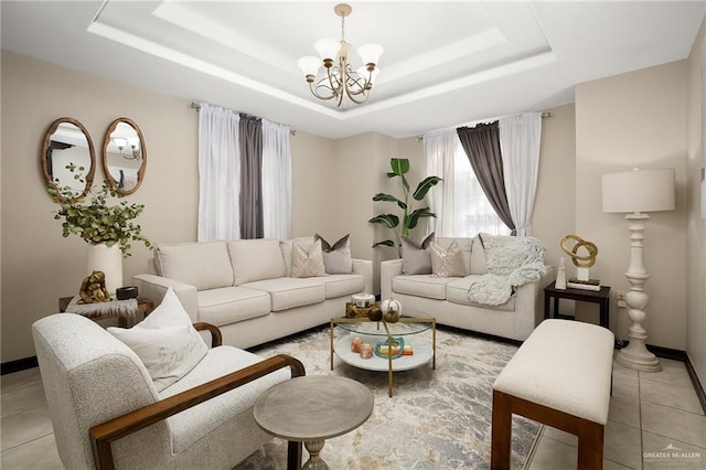 tiled living room with a raised ceiling and a notable chandelier