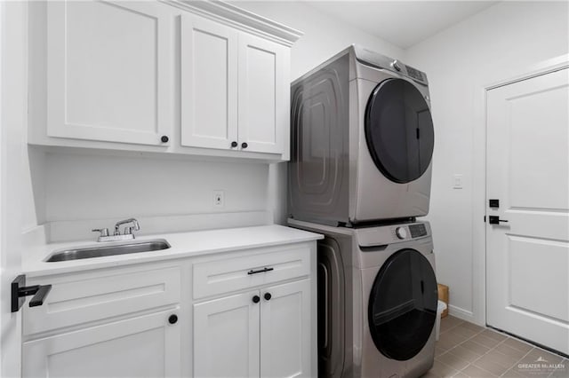 7423 Converse Lk, Brownsville, TX 78520 - laundry room featuring estacked washer and dryer, cabinet space, and light tile patterned floors