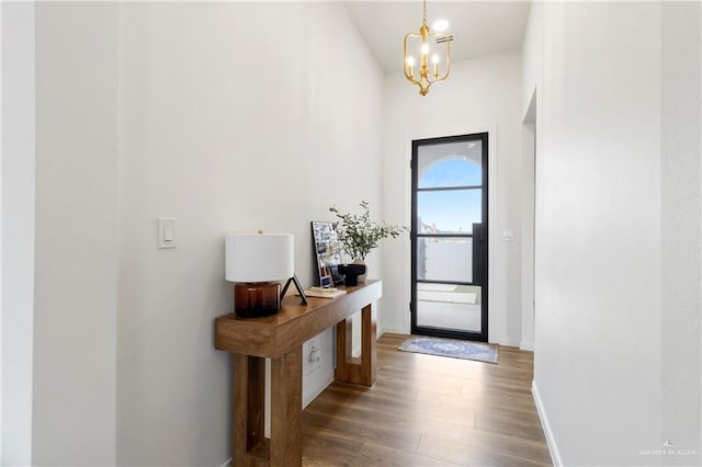 7423 Converse Lk, Brownsville, TX 78520 - doorway to outside featuring wood finished floors, a chandelier, baseboards, and high vaulted ceiling