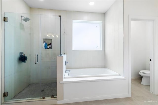 7423 Converse Lk, Brownsville, TX 78520 - full bathroom featuring toilet, a garden tub, a shower stall, and tile patterned flooring