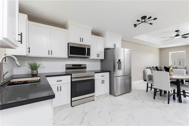 1712 B St, Mission, TX 78572 - kitchen with appliances with stainless steel finishes, a sink, tasteful backsplash, and dark countertops