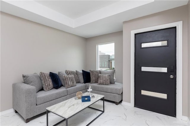 1712 B St, Mission, TX 78572 - living room featuring light marble finish floors, baseboards, and a tray ceiling