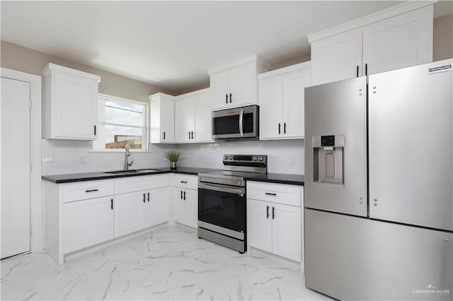 1712 B St, Mission, TX 78572 - kitchen with appliances with stainless steel finishes, a sink, dark countertops, and light marble finish floors