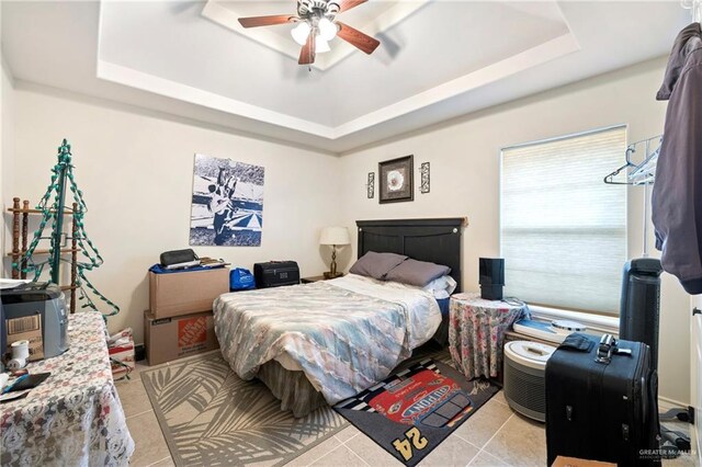 2017 Stonebriar Rd, Harlingen, TX 78552 - bedroom with a raised ceiling, light tile patterned floors, and ceiling fan