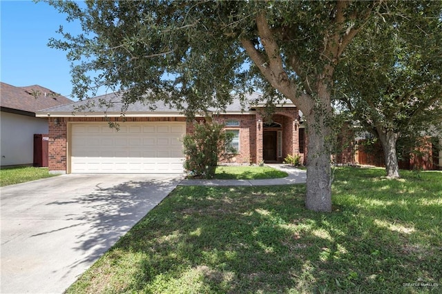2017 Stonebriar Rd, Harlingen, TX 78552 - view of front of home featuring brick siding, an attached garage, driveway, and a front yard