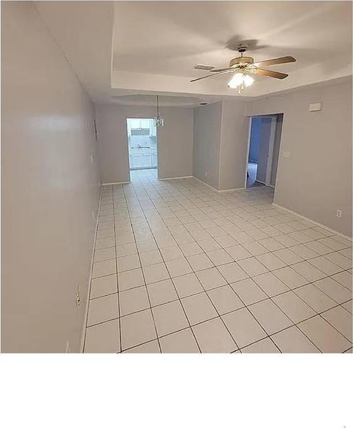 empty room featuring light tile patterned floors and a ceiling fan