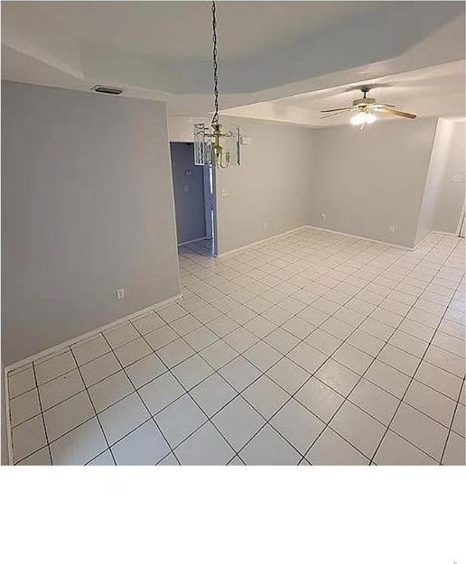 empty room featuring light tile patterned floors and a ceiling fan