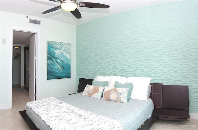 bedroom with light tile patterned flooring, visible vents, and a ceiling fan