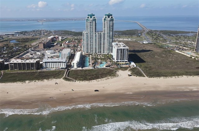 drone / aerial view featuring a beach view and a water view