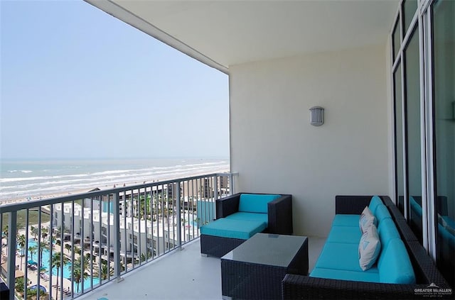 balcony featuring a view of the beach, an outdoor living space, and a water view