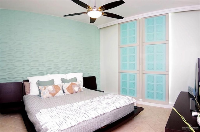 bedroom with light tile patterned floors and a ceiling fan