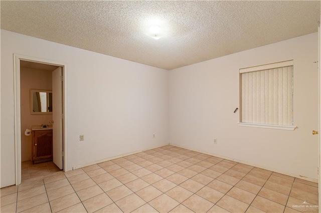 2512 Dallas Ave, Mcallen, TX 78501 - unfurnished room with light tile patterned floors and a textured ceiling