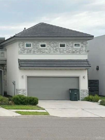 2425 May St, Mission, TX 78573 - view of property exterior featuring stucco siding, a garage, concrete driveway, and stone siding
