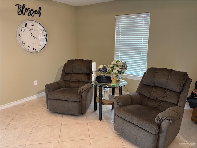 living area featuring light tile patterned floors and baseboards
