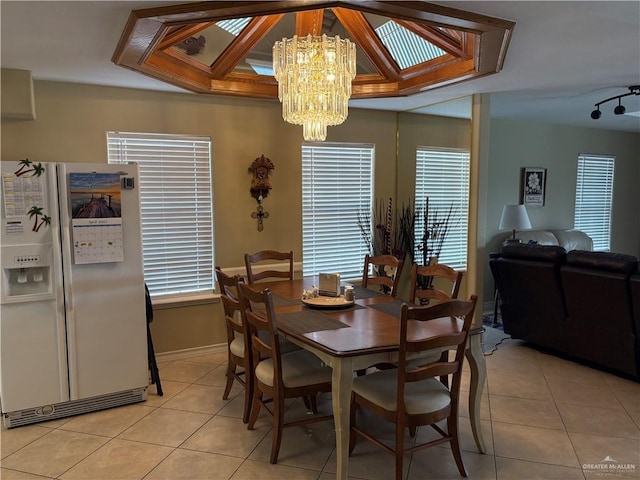 dining area with an inviting chandelier and light tile patterned flooring