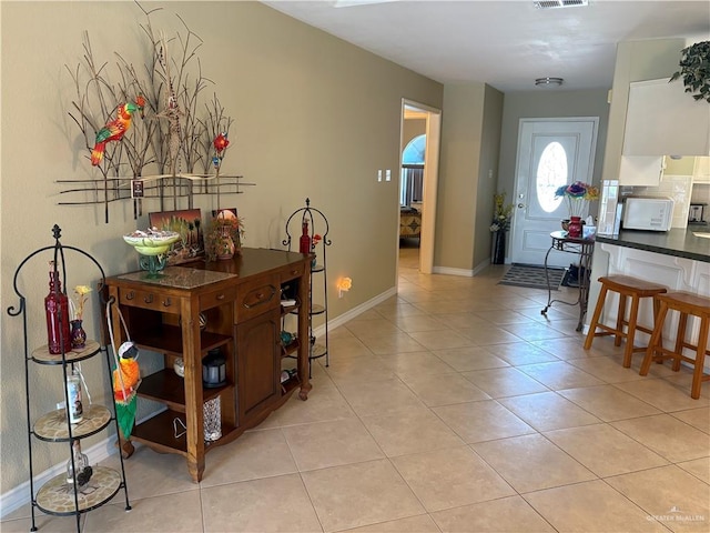 entrance foyer featuring light tile patterned flooring, baseboards, and visible vents