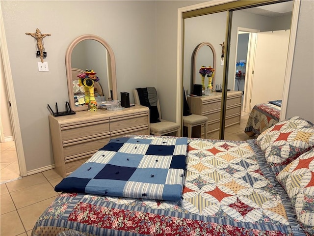 bedroom with light tile patterned flooring and a closet