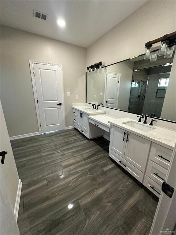 bathroom with vanity and a shower with door