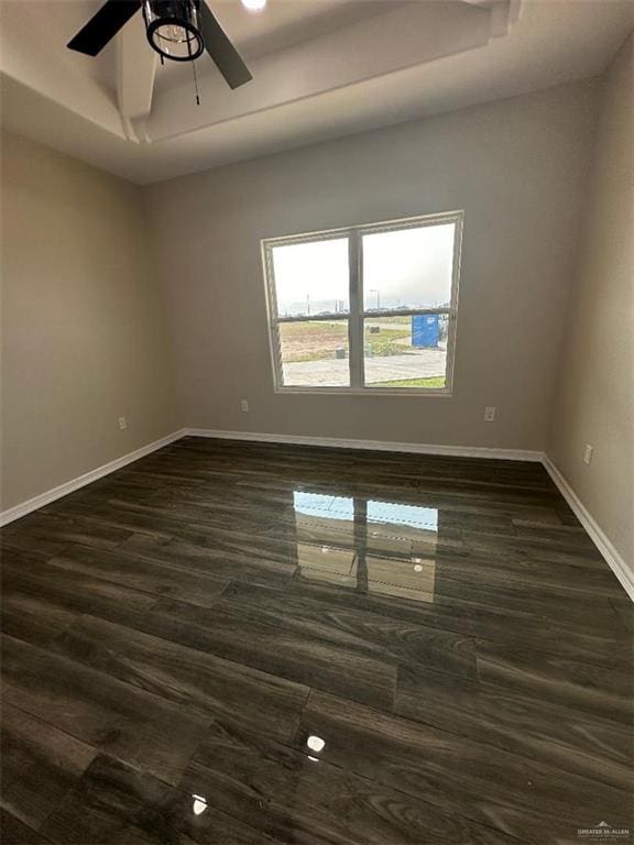 unfurnished room with ceiling fan and dark wood-type flooring