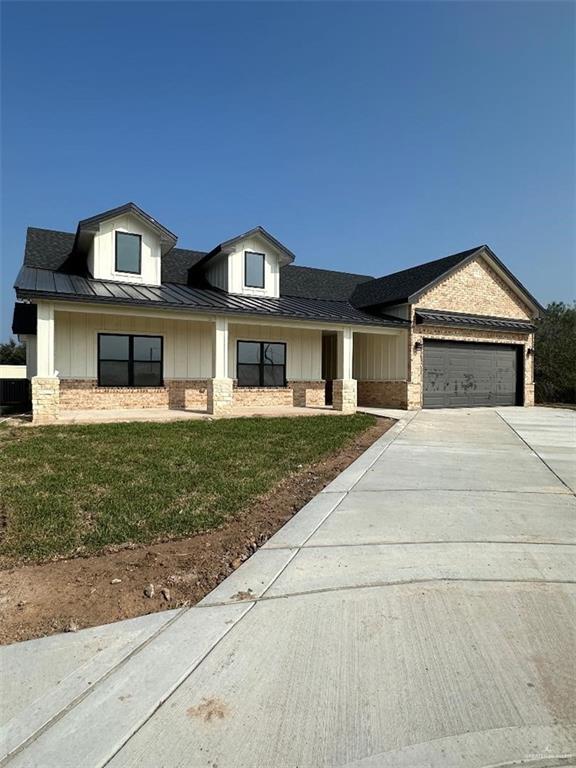 view of front of property with a garage and a front yard