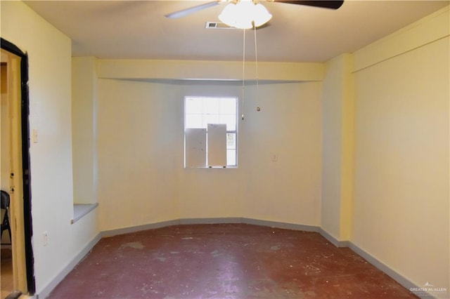 unfurnished room featuring ceiling fan and concrete floors