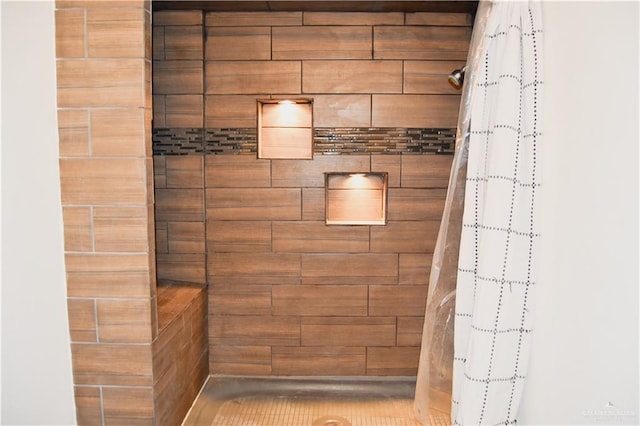 bathroom with wood walls and walk in shower