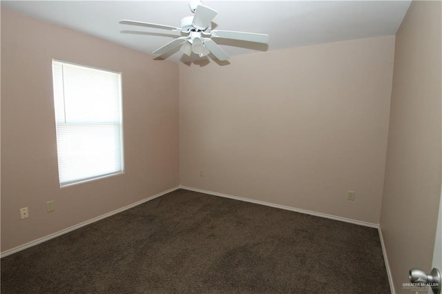 carpeted spare room featuring ceiling fan