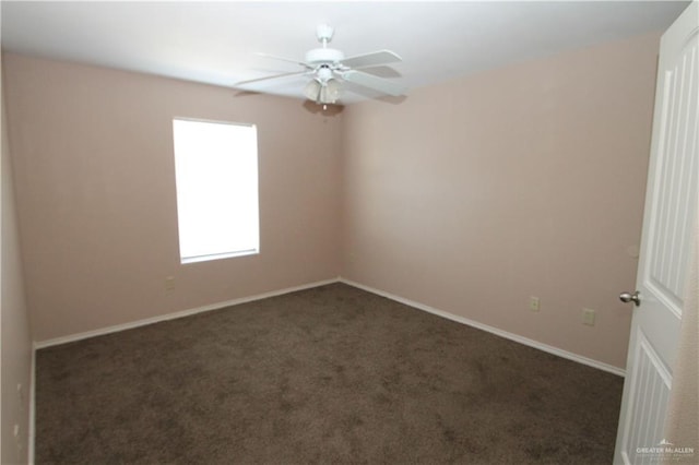 unfurnished room featuring ceiling fan and dark colored carpet