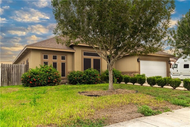 view of front of home with a garage and a front yard