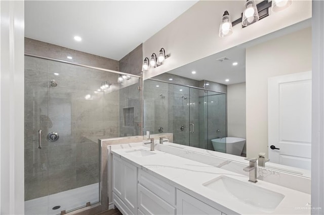 bathroom with vanity and independent shower and bath