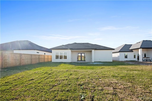 back of house featuring a lawn