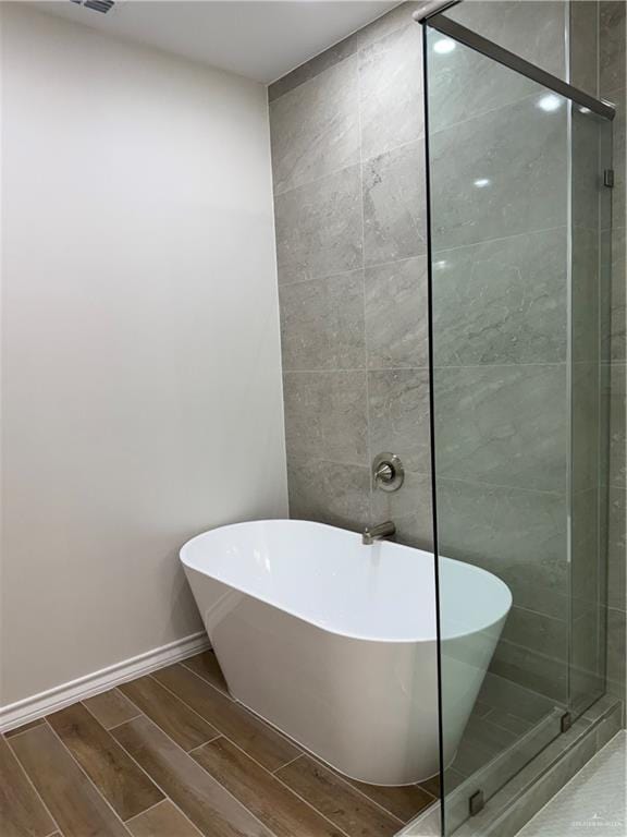 bathroom featuring separate shower and tub