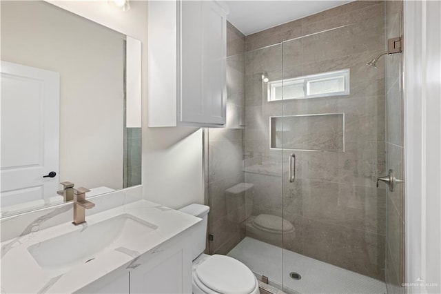 bathroom featuring walk in shower, vanity, and toilet