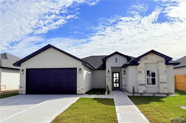 view of front of home featuring a garage and a front yard