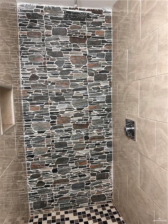 bathroom with tiled shower