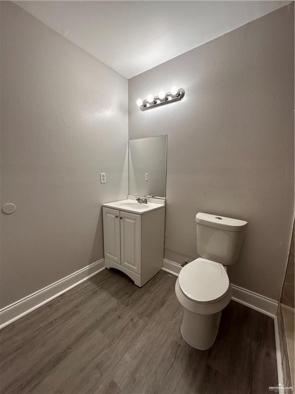 bathroom featuring vanity, wood-type flooring, and toilet