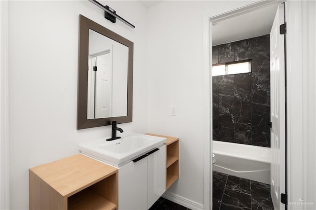 full bathroom featuring vanity, tiled shower / bath combo, and toilet