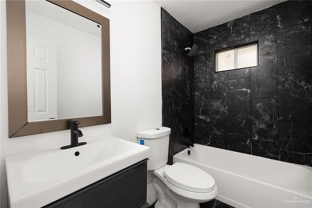 full bathroom with vanity, toilet, and tiled shower / bath