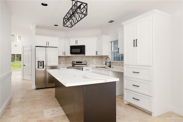 kitchen with white cabinets, sink, decorative light fixtures, a kitchen island, and stainless steel appliances